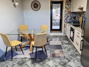 a dining room with a glass table and chairs at Salt Field Residence in Strunjan +2 photos