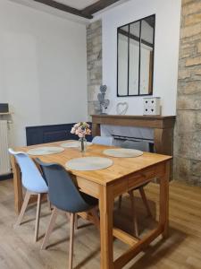a wooden table and chairs in a room at Balnéo in Vesoul