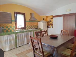 a kitchen with a table and chairs and a sink at Casale del Principe Itri in Itri