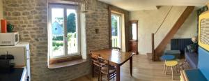 a living room with a table and a window at Gîte de la Ressourcery in Sainte-Marie-du-Mont