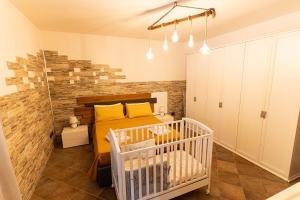a small bedroom with a bed and a crib at Villa Vinne Cirase in Castiglione dʼOtranto +80 photos