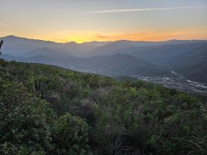 a view of a valley with mountains in the distance at Charmante Villa avec Piscine en Bord de Mer a beni ksila in Tizouiar