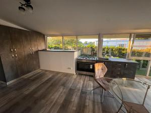a kitchen with a stove and a counter top at Sico Hostel Centru in Craiova +19 photos