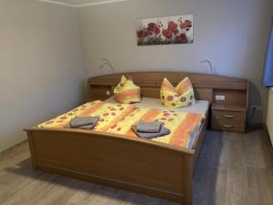a bedroom with a bed with two pillows on it at Ferienwohnung Flecken Zechlin in Flecken Zechlin