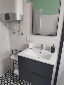 a bathroom with a sink and a mirror at Te Amantia Apartment in Tirana