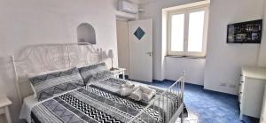 a bedroom with a bed with two stuffed animals on it at Sea View Apartments Amalfi Coast by Amalfi Coast with Locals in Conca dei Marini +22 photos