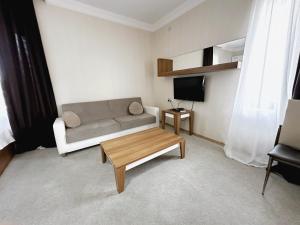 a living room with a couch and a coffee table at Palm Beach Hotel in Anaklia