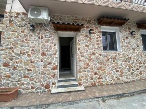 a stone building with a fan on the side of it at Stone house 48 m in Acharnes