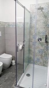 a glass shower in a bathroom with a toilet at Casa Vacanze Mimose in Palinuro