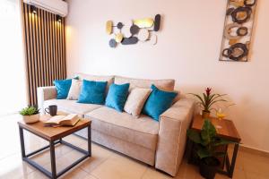a living room with a couch with blue pillows at Relax Mandre 200m from the beach Sea view in Mandre
