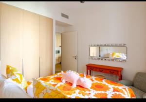 a bedroom with a bed with a stuffed pig on it at Exquisite 1-Bedroom with Pool Scenery in Dubai Creek Harbour in Dubai +18 photos