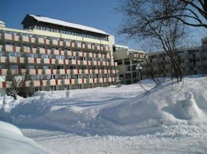 a pile of snow in front of a large building at Moderne Wohnung in St Englmar in Sankt Englmar