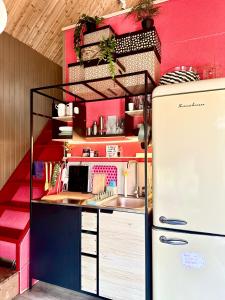 a toy kitchen with a refrigerator in a room at Amazing little house on an island with garden in Rīga