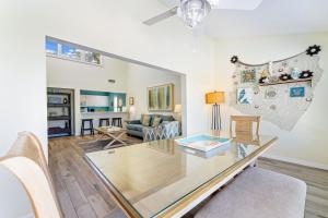 a living room with a glass table and a couch at Living the Dream By Beachside Management in Siesta Key