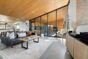 a living room with a couch and a table at Tanglewood Cabin-Lake Access-Private-Modern in Rambo Riviera