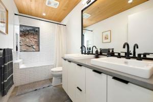 a bathroom with two sinks and a toilet at Tanglewood Cabin-Lake Access-Private-Modern in Rambo Riviera +25 photos