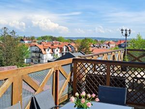 a balcony with chairs and a view of a city at Apartament Lubię Błękit in Rowy