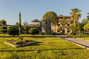 a park with a building in the background at Palm Beach Hotel in Anaklia
