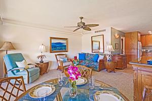 a living room with a table and a couch at Maui Eldorado - G108 - Stay in the Heart of Kaanapali in Kahana