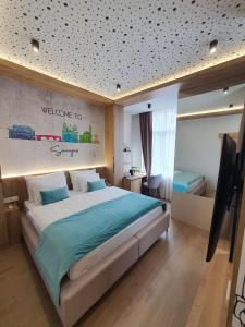 a bedroom with a large bed with a sign on the wall at Rina Apartments in Sarajevo