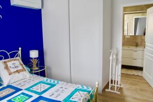 a bedroom with a blue wall and a bed at Détente et évasion entre Hossegor et Biarritz in Tarnos
