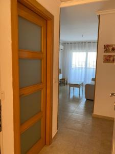 a door to a room with a living room at Edificio TORREMAR vistas al mar, orientación norte, Wifi y Smart-TV in Oropesa del Mar