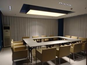 a conference room with a table and chairs in it at Jinjiang Inn Wuhan Wuchang Railway Station in Wuhan