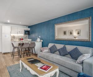 a living room with a couch and a table at Apartments Du Louvre St Honoré in Paris