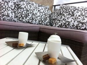 a coffee table with two white vases on top at Villa Pieds dans l eau in Porto-Vecchio