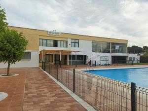 a building with a swimming pool in front of it at Estudio Taupe in Matalascañas