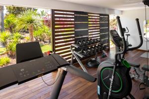 a room with a gym with a treadmill at Hotel Boutique Ses Pitreras in San Antonio Bay