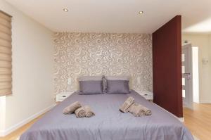 En eller flere senge i et værelse på Apartment Uptown