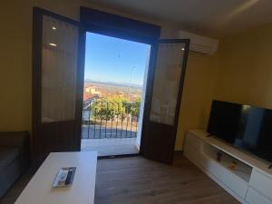 a living room with a large window and a television at Apartamento Barranquilla in Poyales del Hoyo