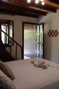 a bedroom with a white bed with towels on it at Gialova Filoxenia in Gialova +15 photos