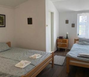 a bedroom with two beds with towels on them at Kuća kod Tala in Šabac