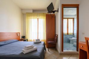 Postel nebo postele na pokoji v ubytování Hotel Vico Alto Siena + 37 fotografií