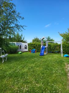 a yard with a playground with a slide at Domki Letniskowe Gris in Grzybowo