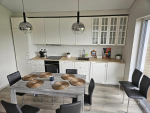 a kitchen with a table with baskets on it at Blue House with terrace in Palanga