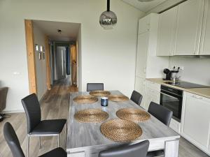 a kitchen with a wooden table with rattan plates on it at Blue House with terrace in Palanga