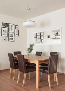 a dining room with a wooden table and chairs at Spacious cozy home and sunny terrace in Nida in Neringa