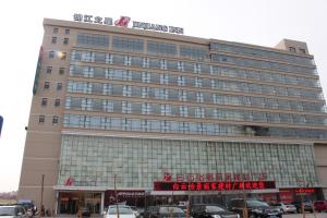 a large building with a sign on top of it at Jinjiang Inn Jincheng Zhongyuan Street in Jincheng