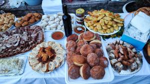 a table with many different types of pastries on it at Rustic house in Bar