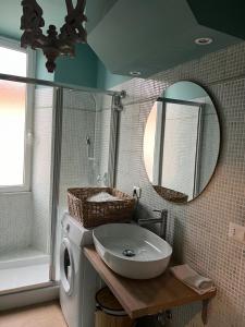 a bathroom with a sink and a washing machine at La terrazzina OLTRE HOME HOLIDAYS in Sanremo