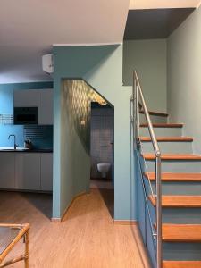 a staircase in a room with a kitchen and a bathroom at La terrazzina OLTRE HOME HOLIDAYS in Sanremo