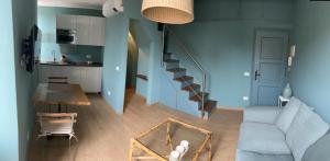 a living room with a couch and a table at La terrazzina OLTRE HOME HOLIDAYS in Sanremo +5 photos