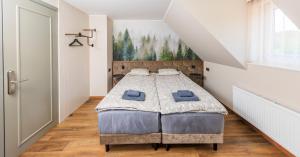 a bedroom with a large bed in a attic at Reiu Holiday Centre in Pärnu