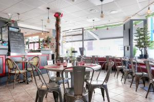 a dining room with tables and chairs in a restaurant at La Rotonde in Saint Malo