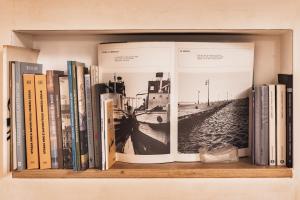 a shelf filled with books on a wall at Casa Saba Trieste Luxury Apartment in Trieste