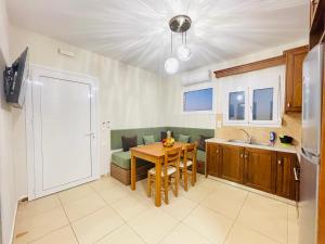 a kitchen and living room with a table and a kitchen and a dining room at Lafo Rooms in Elafonisi