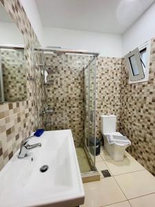 a bathroom with a sink and a toilet at Lafo Rooms in Elafonisi